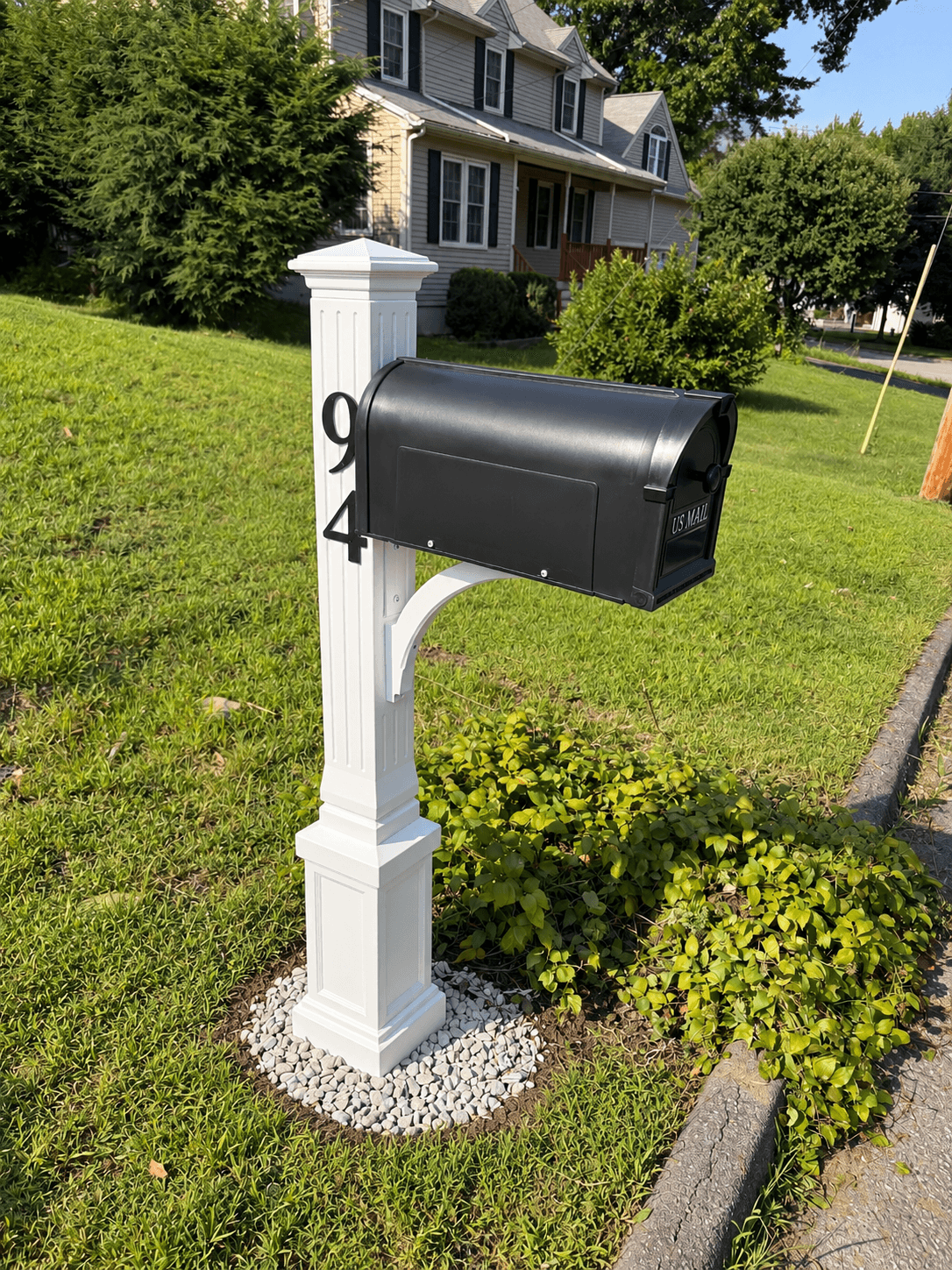 After: White fluted vinyl mailbox post with a black mailbox, house number 94, and a white stone base